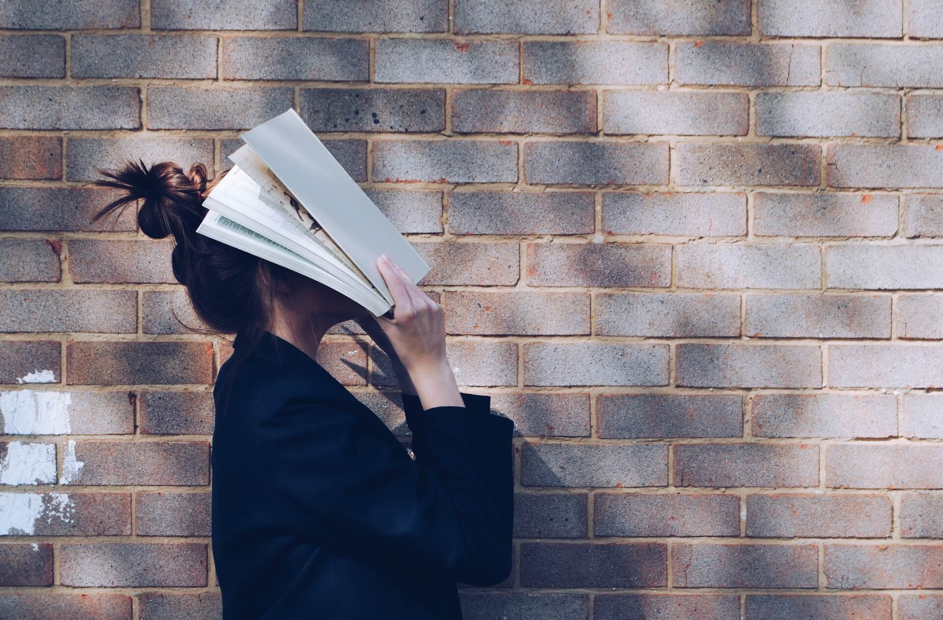 Girl reading book language learning