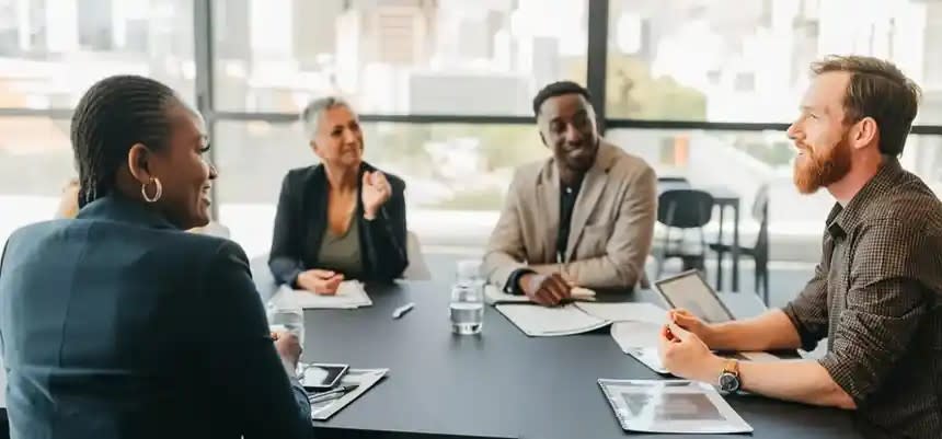 Five sales leaders discussing sales readiness review results and skill gap data around a boardroom table