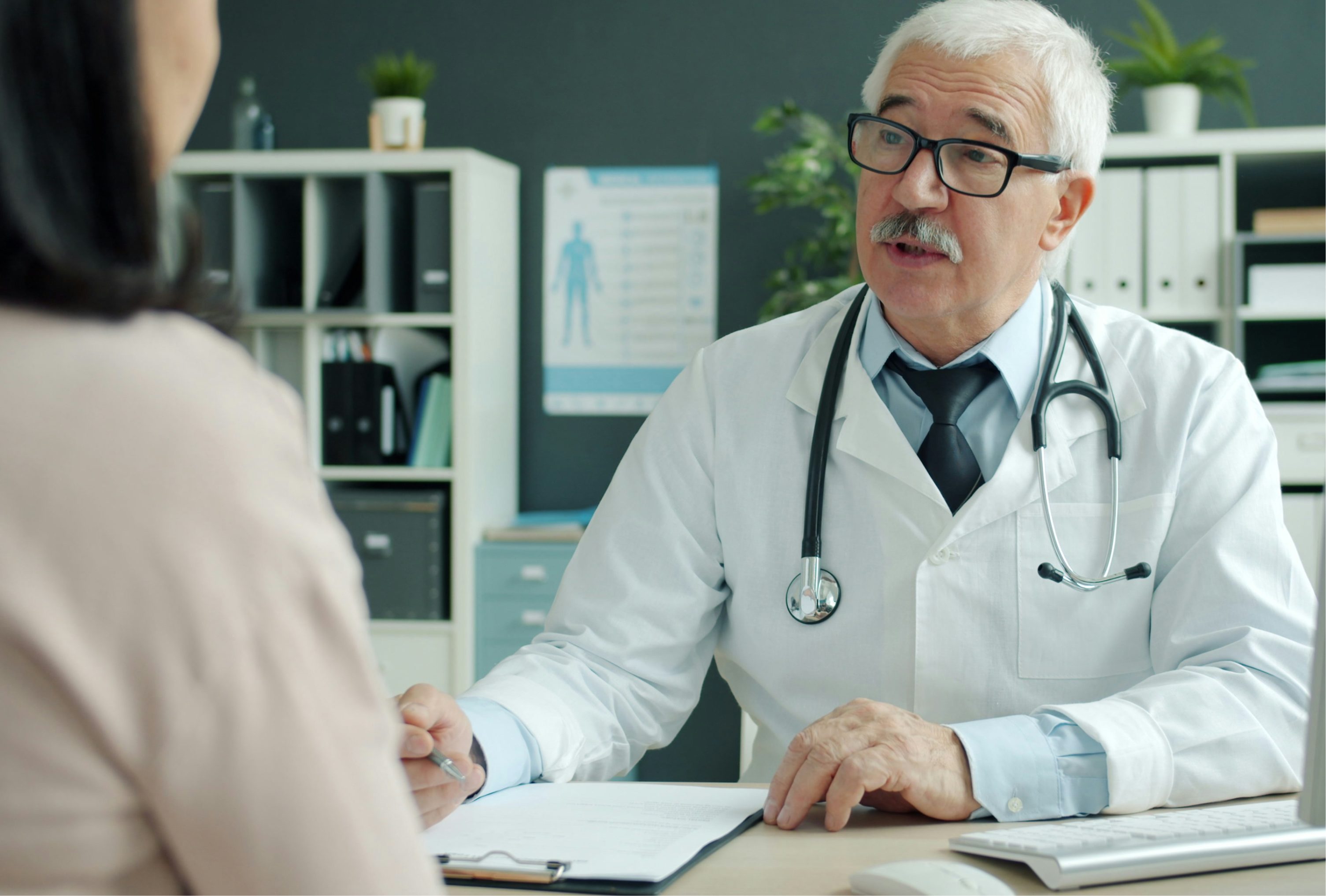Medical device rep and practice administrator reviewing a device on a tablet