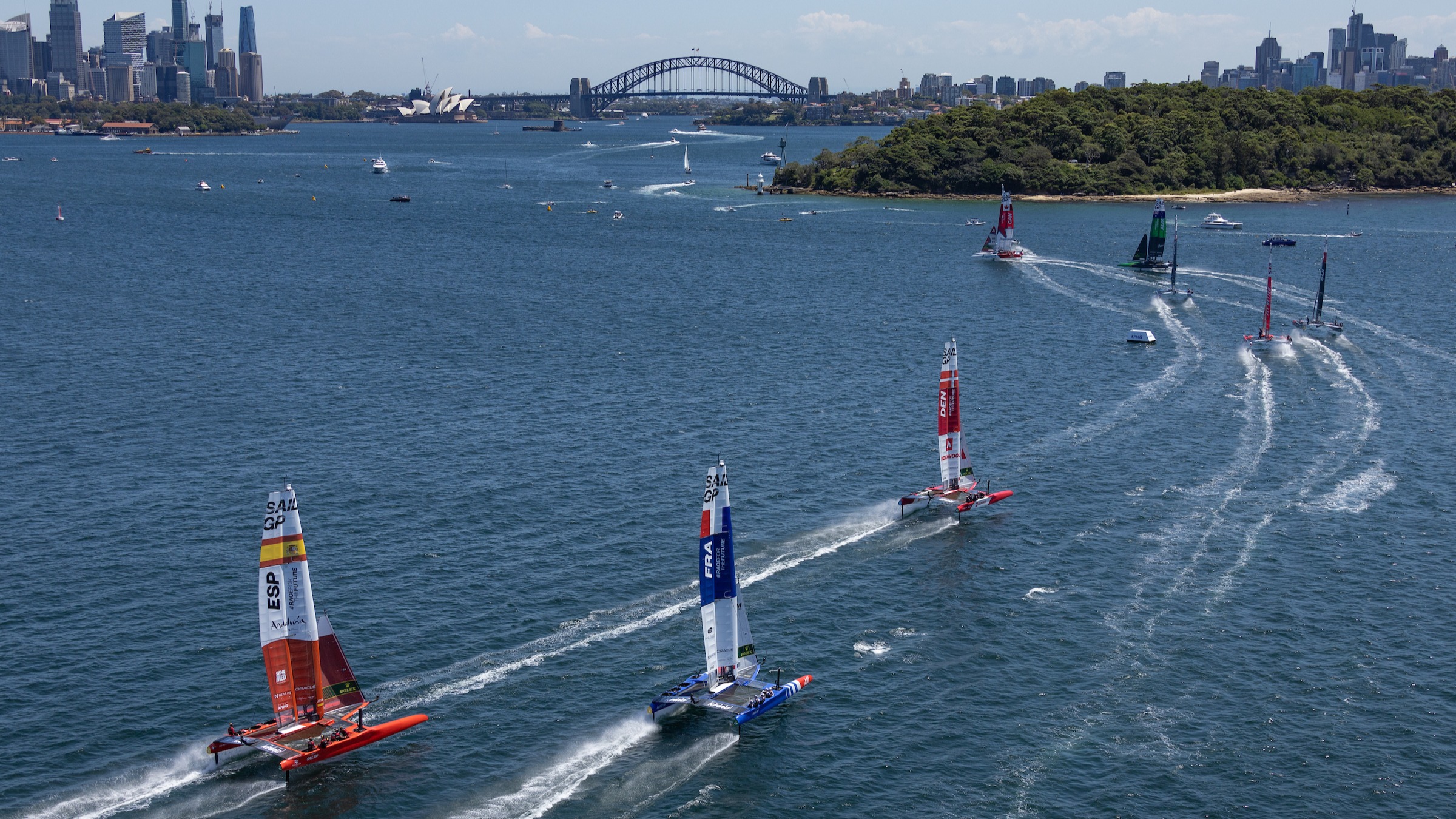 Season 3 // Australia Sail Grand Prix // Fleet races towards bridge in Sydney