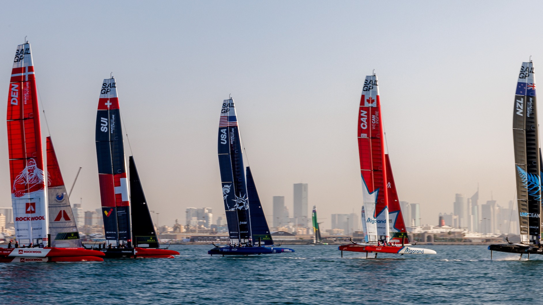 Season 3 // Dubai Sail Grand Prix // Fleet against city skyline in practice racing 