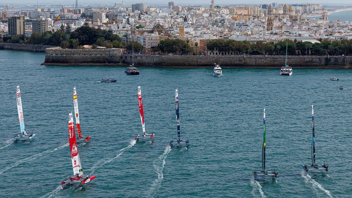 Season 3 // Spain Sail Grand Prix // Fleet sailing towards Cadiz skyline
