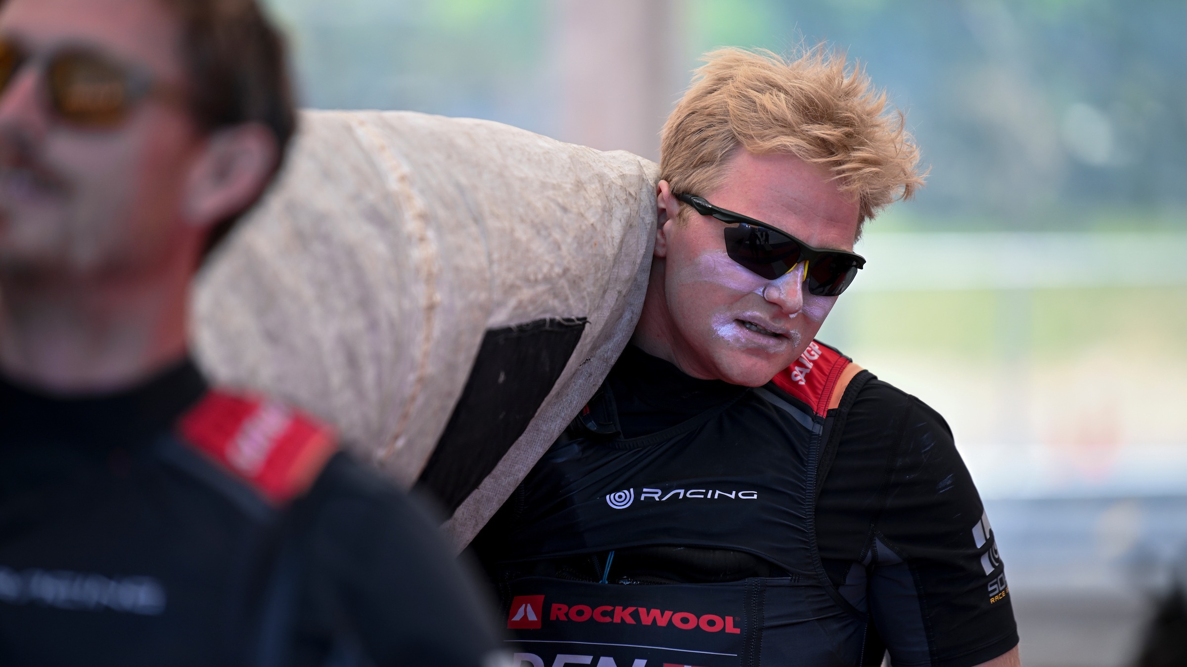 Season 3 // Denmark SailGP Team // Grinder Hans-Christian Rosendahl carries jib from tech base