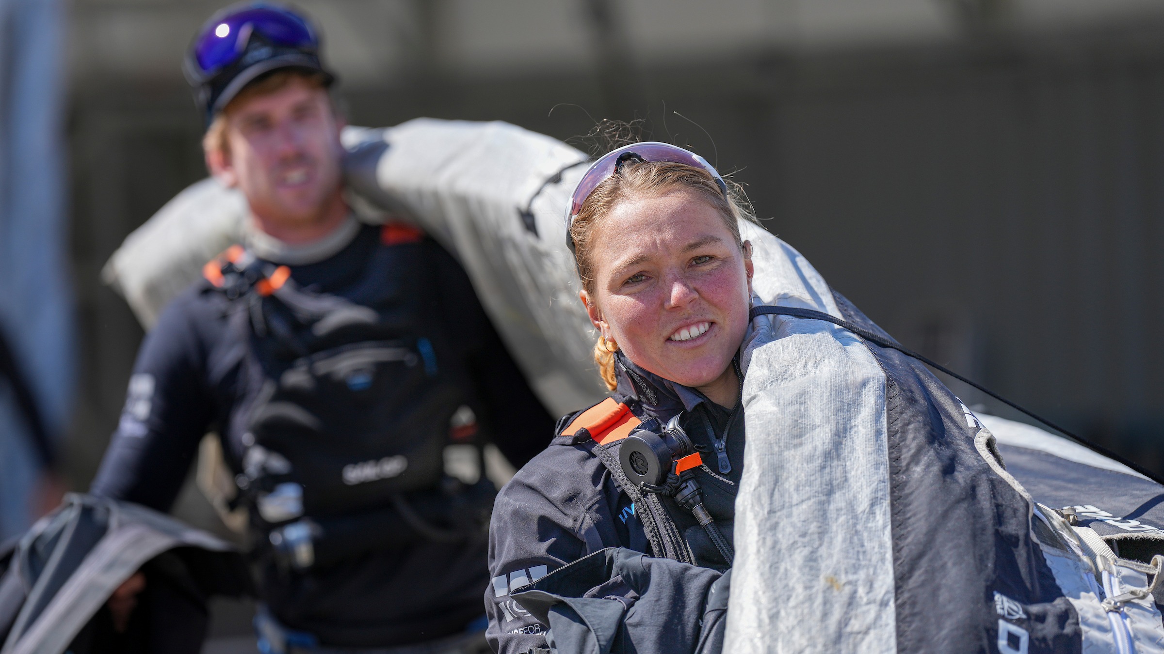 Season 3 // New Zealand Sail Grand Prix // Liv Mackay carrying sail with Pete Burling  