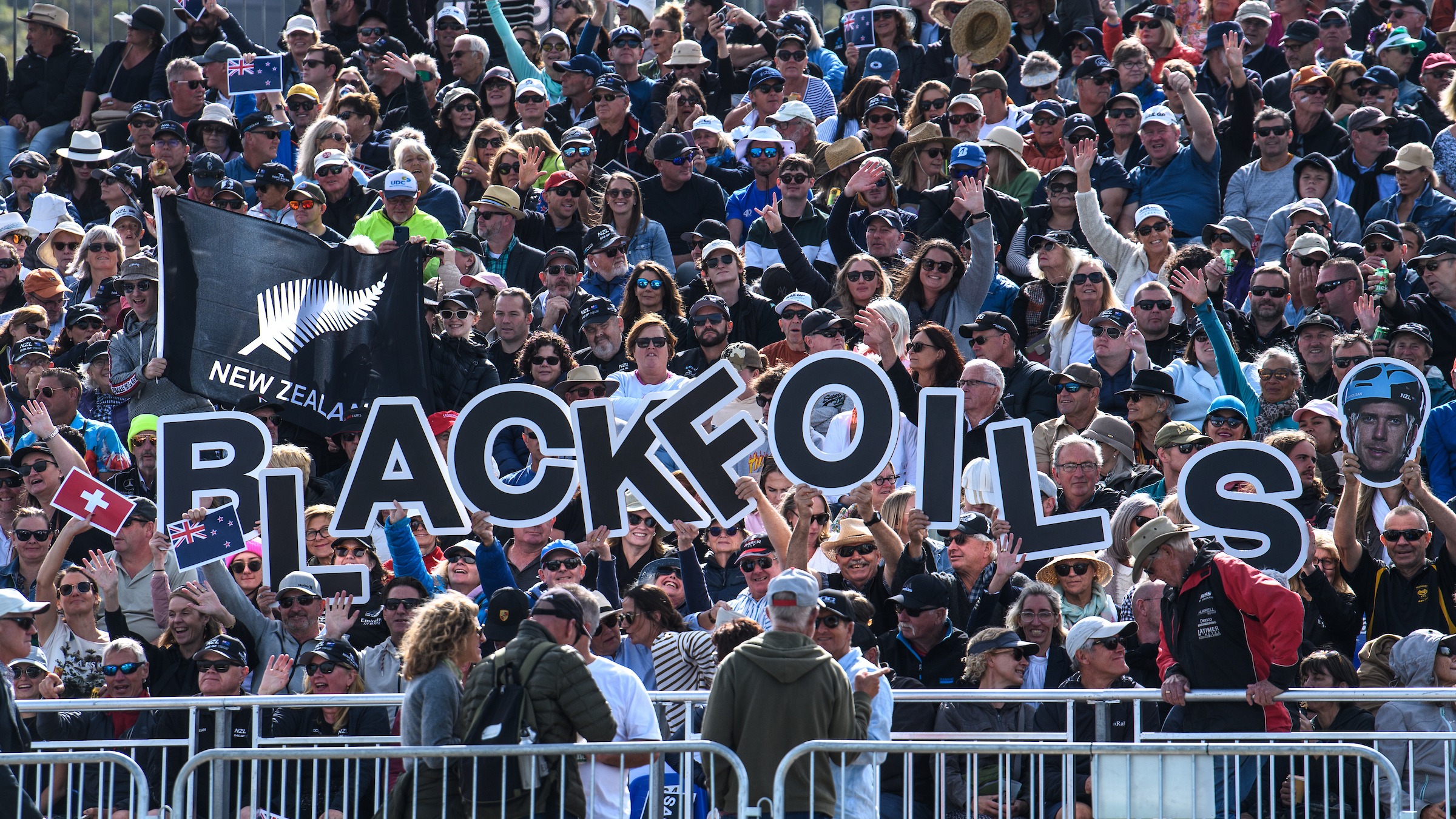 Season 4 // Crowds hold Black Foils signs in Christchurch 