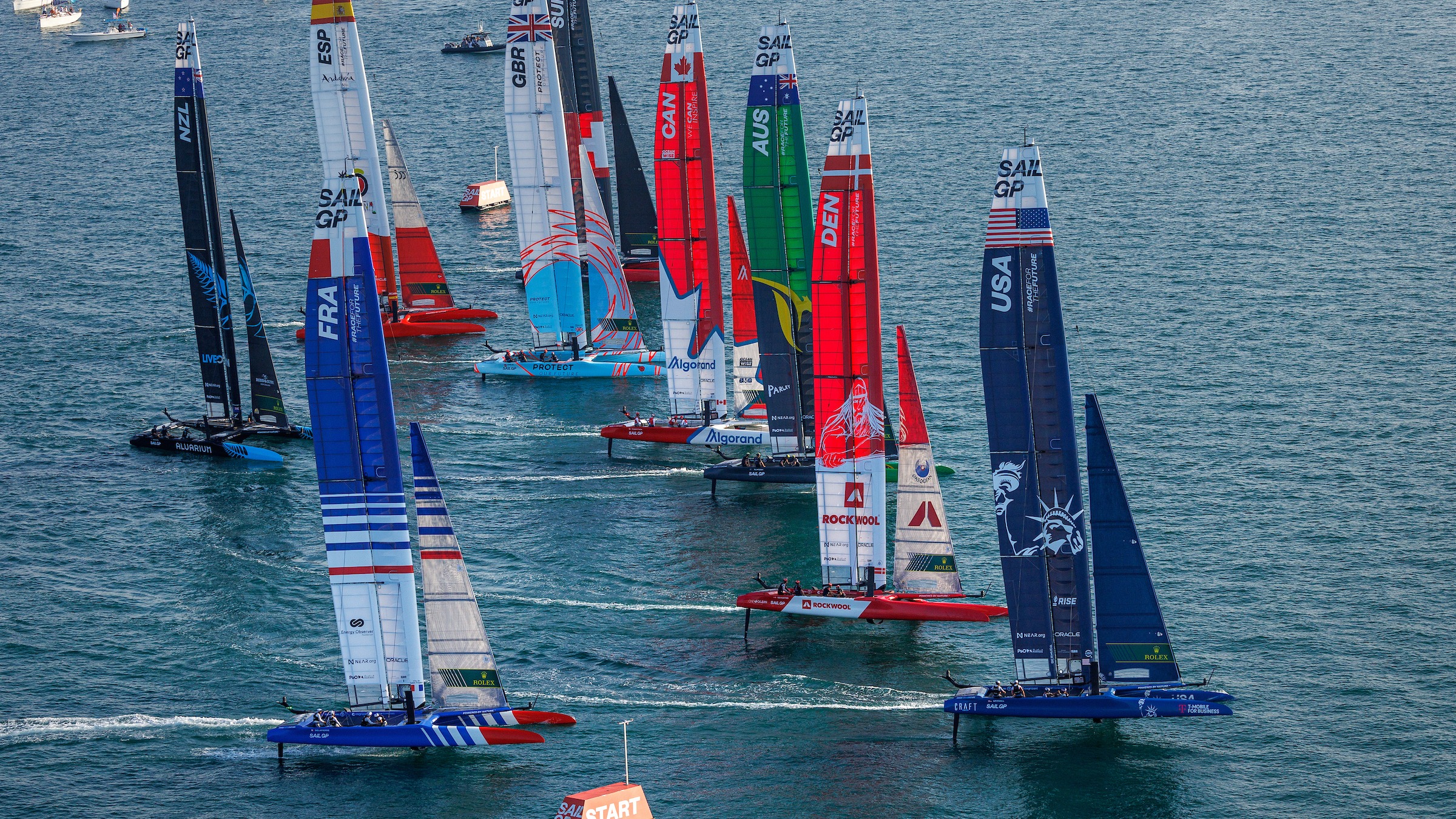 The fleet blasts over the start line on the first day of racing 