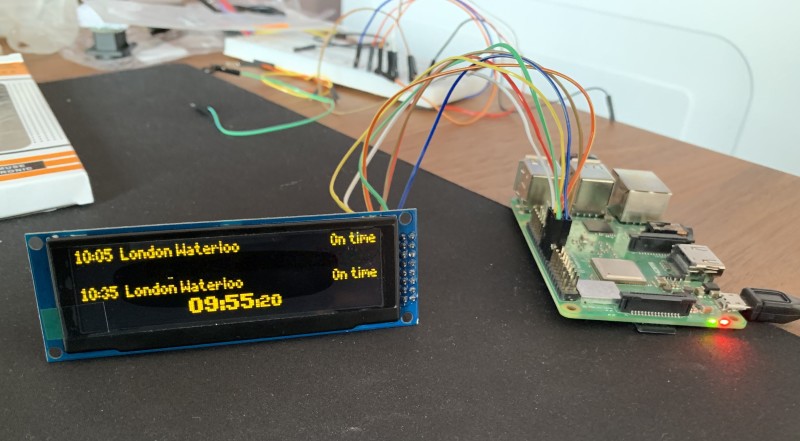 A Raspberry Pi 3B+ connected to a £25 dot-matrix display shows real-time train departure times pulled from the TransportAPI using Python 3