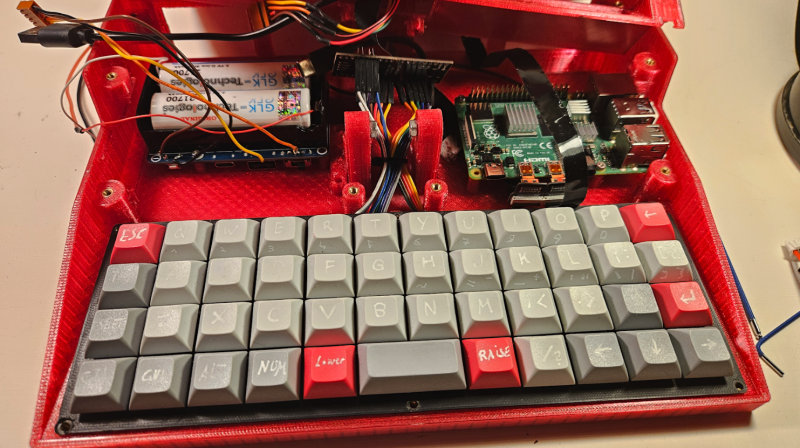 The ortholinear mechanical keyboard has 47 keys and it uses the Raspberry Pi Pico W running KMK firmware powered by CircuitPython. It’s possible to fit any keycap or switch to this keyboard, but Michael bought an inexpensive set of blanks from Amazon