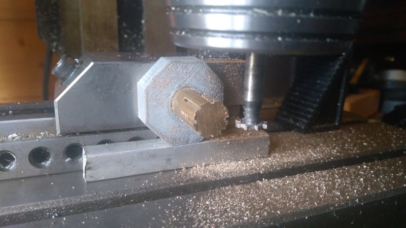 Figure 3: Using a 3D-printed press fit collar on a piece of brass bar to perform eight equidistant milling operations around its circumference