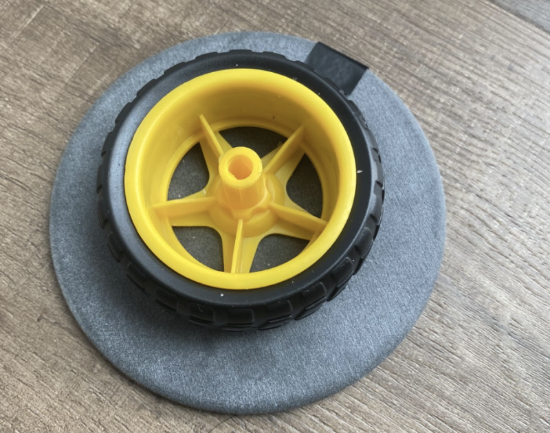 Superglued to a wheel that connects to the stepper motor, the 3D-printed plate was designed by Yohei