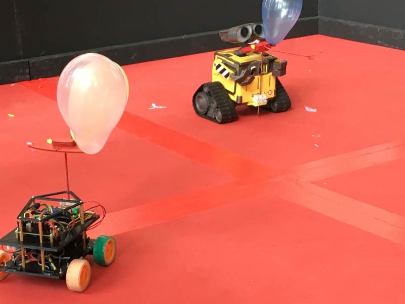 Rival robots circle each other in the Pi Noon ring at Pi Wars 2019
