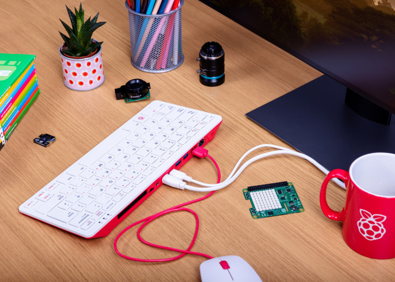 The Raspberry Pi 400 with a mouse, USB-C power, and HDMI cable attached