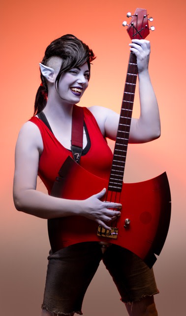 The axe-shaped guitar completes Allie’s cosplay based on Adventure Time’s Marceline character