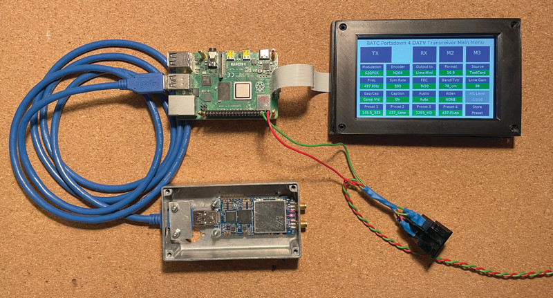 Here we can see the three key parts for the proof of concept: Raspberry Pi, SDR connected by USB, and touchscreen. Dave created the custom touchscreen software to control the system