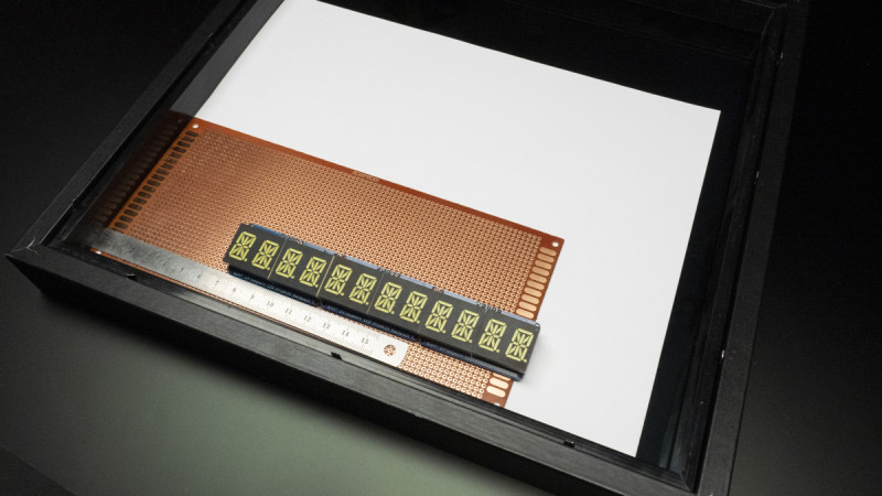 The bright LEDs will shine through the mirror at the lower edge, where the perfboard rests inside the shadow box frame