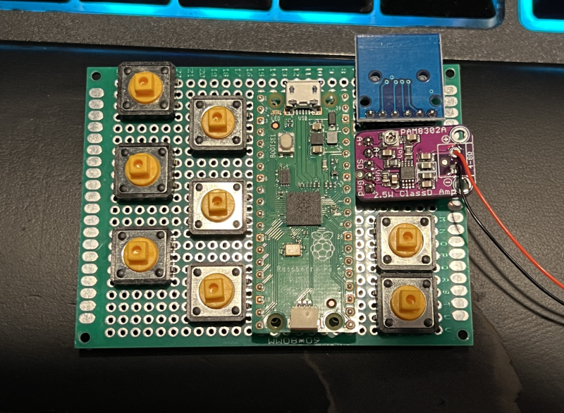 The device makes use of a Raspberry Pi Pico board connected to a protoboard which is wired to the buttons and a PAM8302 2.5 Class D single channel amp