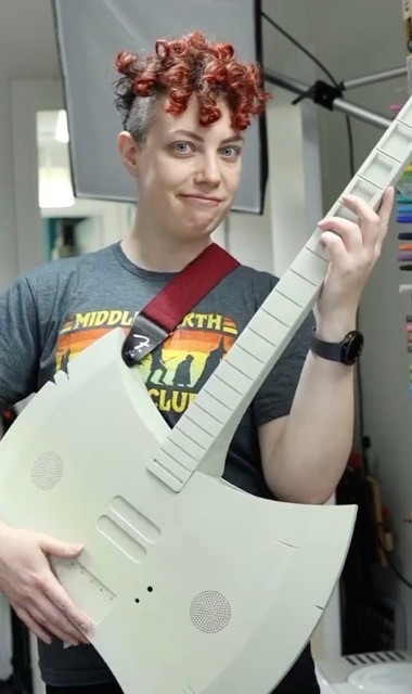 Allie tries on the newly printed and sanded guitar for size