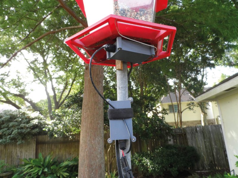 Self-adhesive copper foil tape is placed along each of the six perches of the feeder. Wire is soldered to the tape.