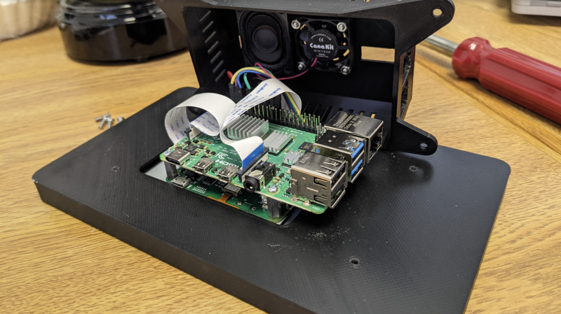  A Raspberry Pi, speaker, and display connector are squeezed into the case