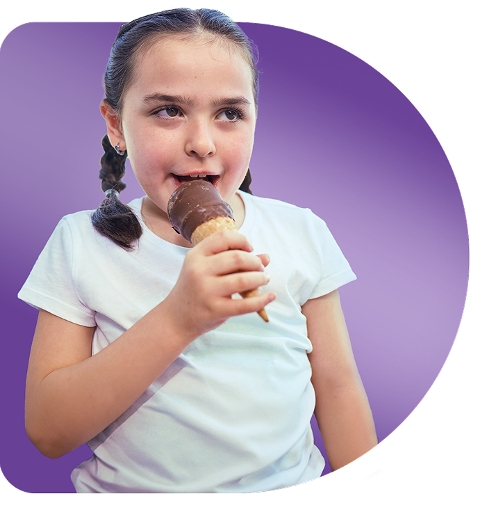 Clare, age 8, living with Rett syndrome, holding her ice cream cone