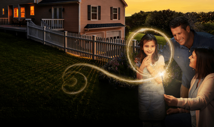 Kate, age 9, living with Rett syndrome, being shown a sparkler by her mom and dad. The light makes a circle around Kate