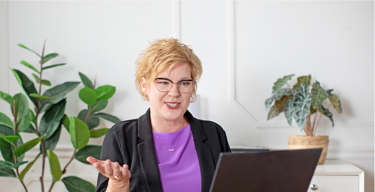 Cheryl, Patient and Community Educator, on her computer