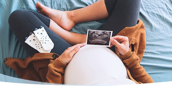 Femme enceinte tenant son ventre