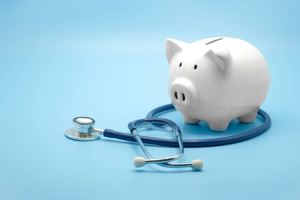 Piggy bank and medical stethoscope