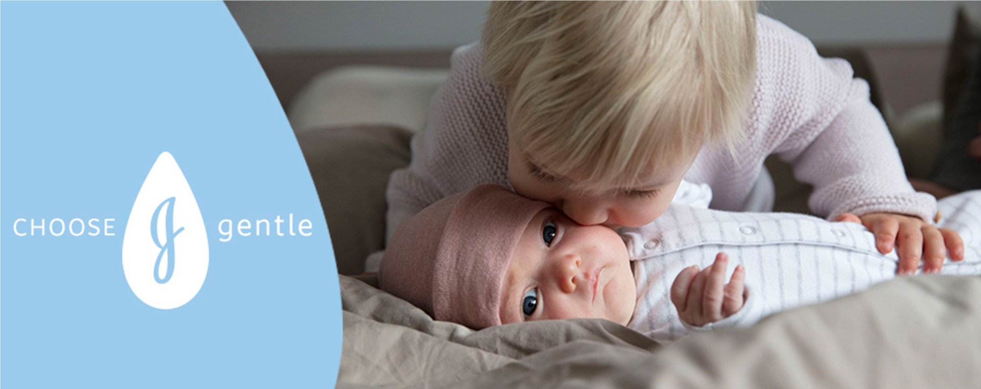 Child kissing baby's cheek