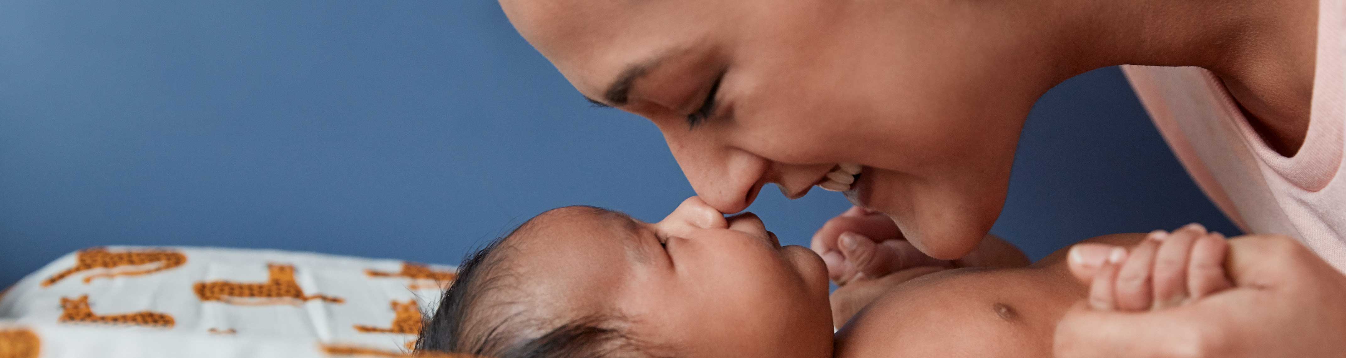 Mom and newborn touching nose to nose