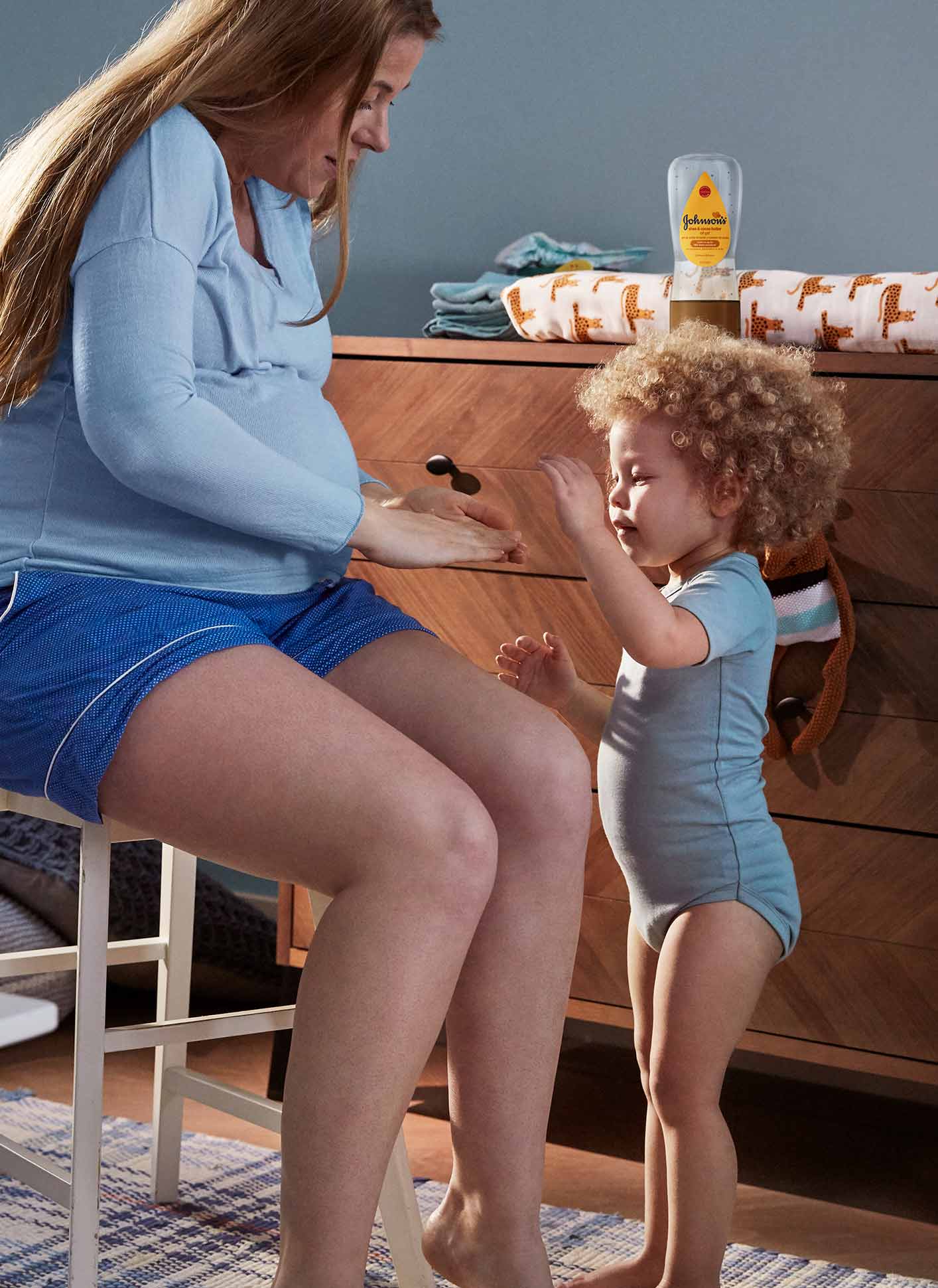 woman applying baby oil into legs