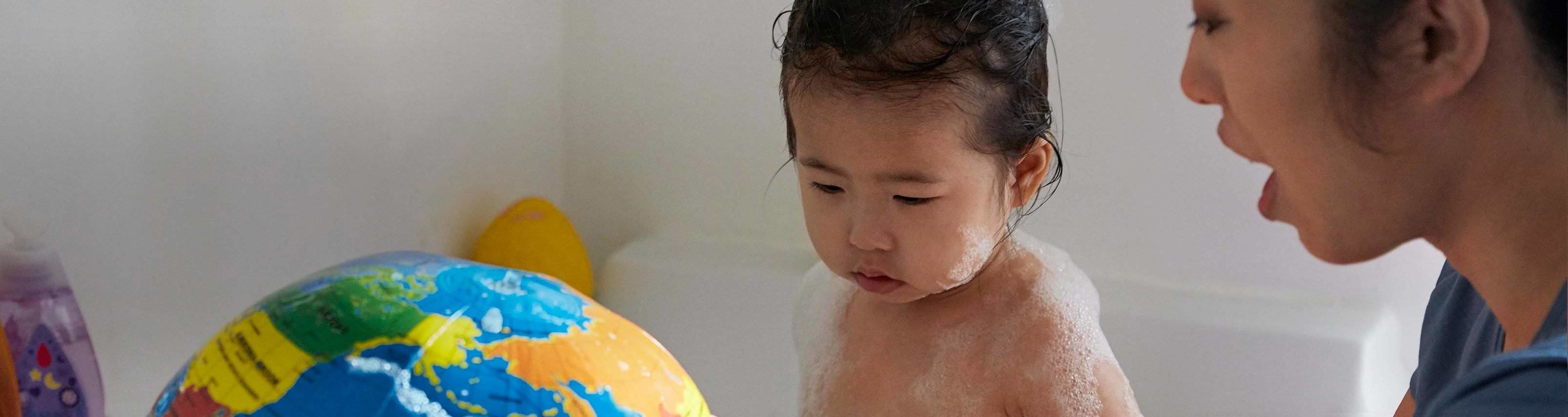 Mother giving baby a bath