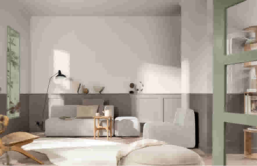 Moderne woonkamer met grijze modulaire bank, tweekleurige muren in wit en grijs, en natuurlijk licht door ramen.