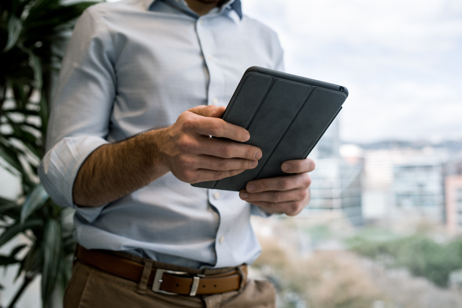 close up of man holding iPad