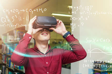 Man using a VR set with equations around him. 