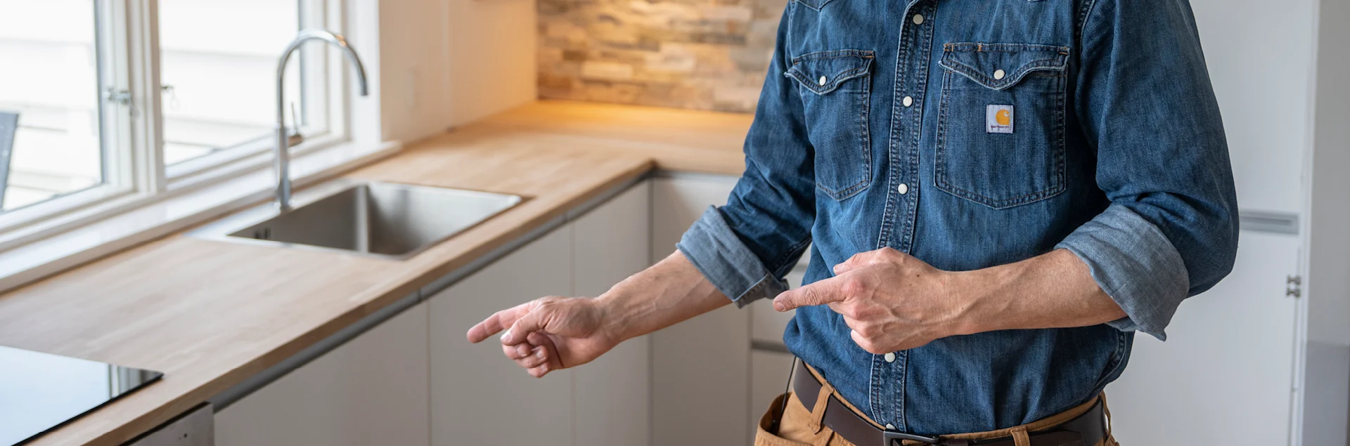 Det færdige resultat er et opfrisket køkken med ny bordplade, køkkenvask og køkkenarmatur.