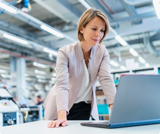 Technology worker looking at a laptop