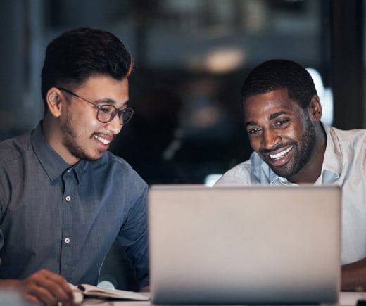 Two people looking at a laptop