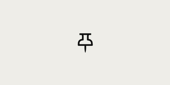 A small black icon depicting a pushpin