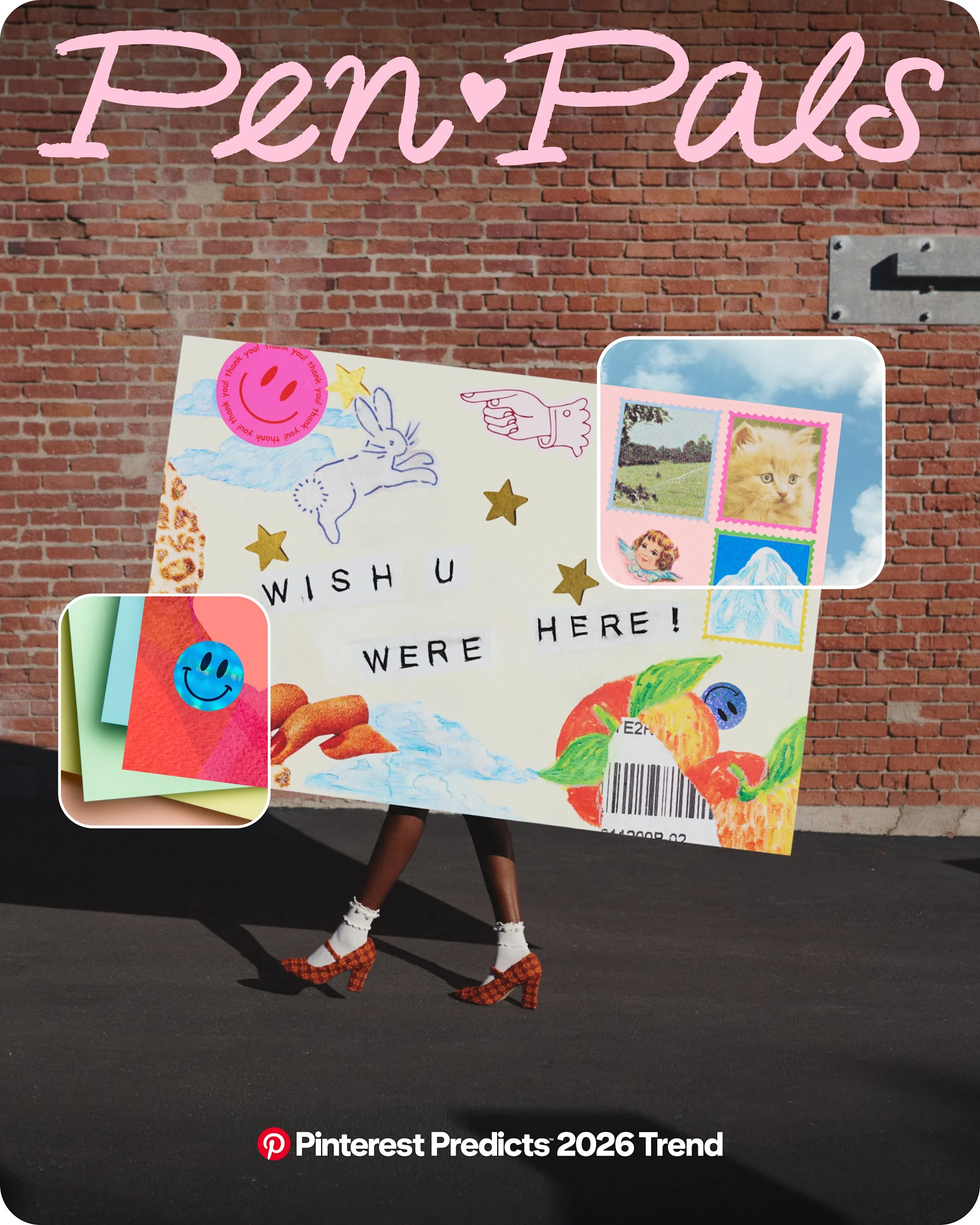 A person walks in front of a brick wall carrying a huge envelope that obscures their body. The envelope says “WISH U WERE HERE!” and is covered in stickers and stamps.