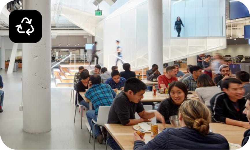 Pinterest employees sit at tables in the office dining area.