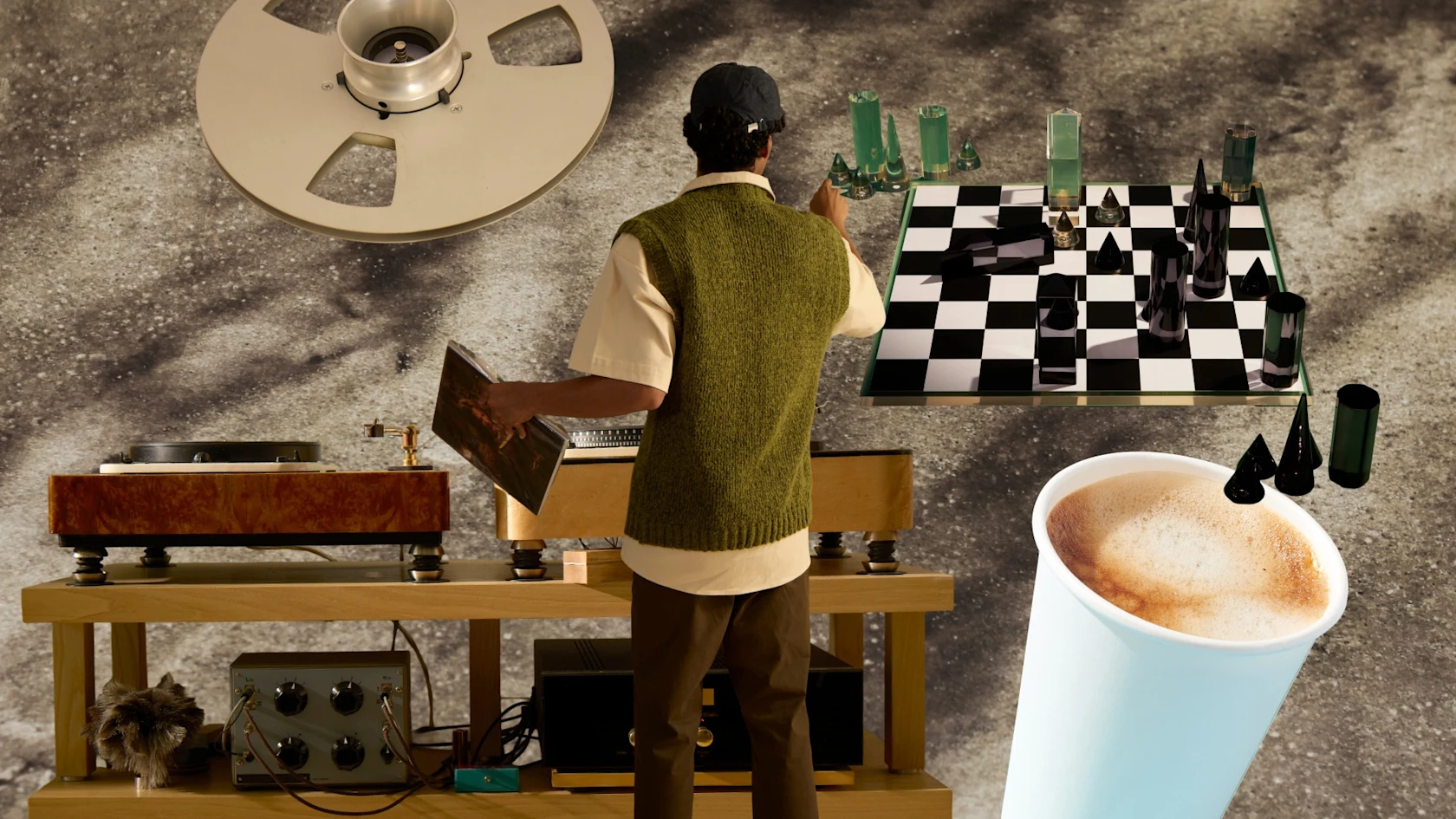 A man in a green sweater vest selects a vinyl record beside vintage audio equipment, a chessboard and a cup of coffee.