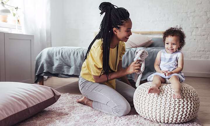 A mother and toddler sharing a joyful moment together