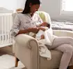 Mother holding her newborn baby, highlighting essential items for newborn care