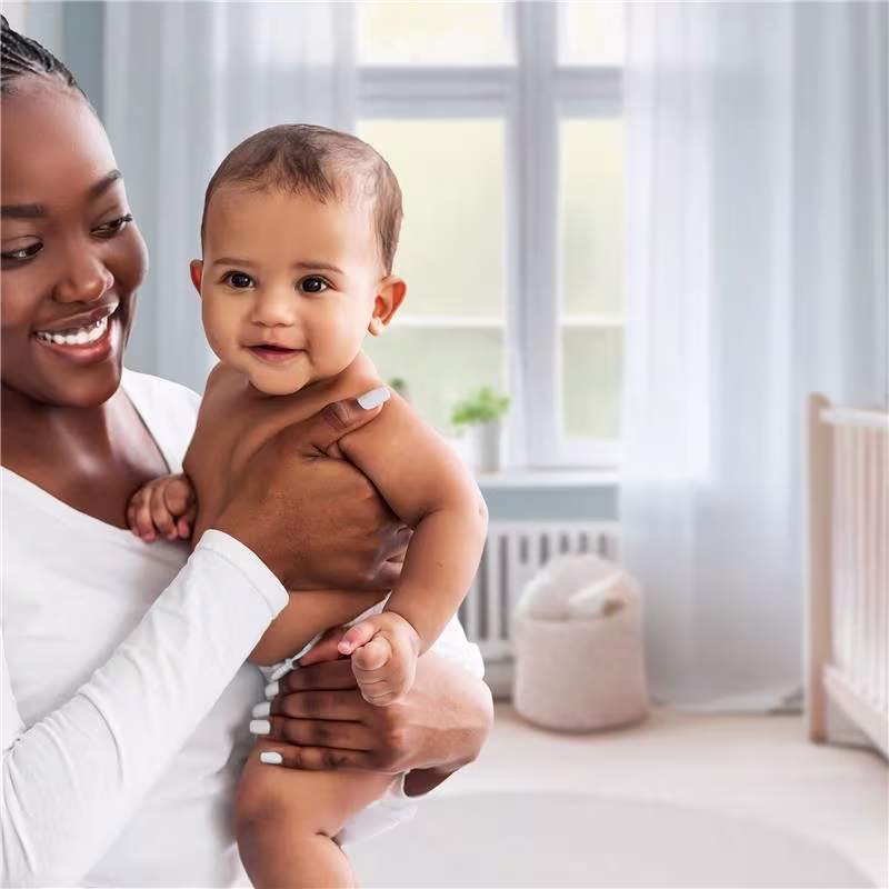 A caring mother holding her baby in the nursery