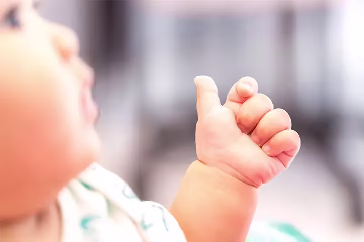 Banner image featuring a baby learning sign language