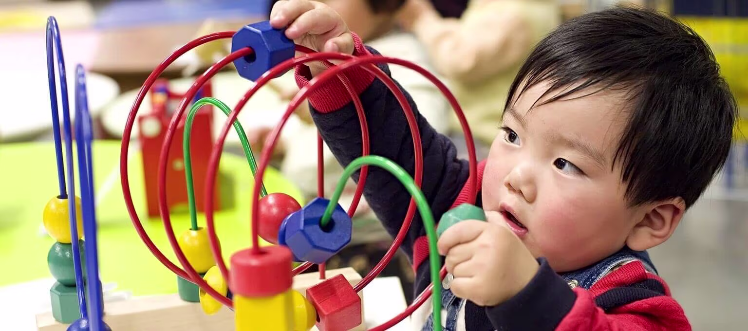 Baby playing with an abacus