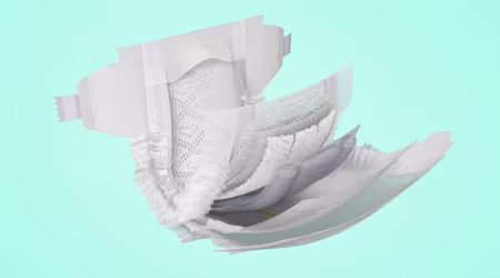 Open Pampers taped diaper showing the inside, with clickable points highlighting ingredients area.