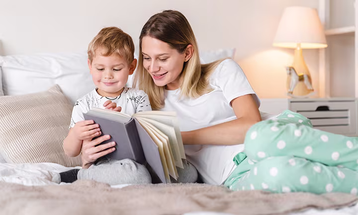A parent reading a book with their child