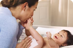 Woman cleaning baby's skin
